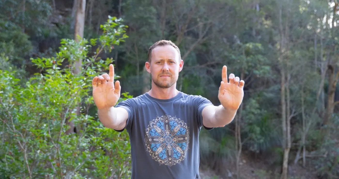 Ross Parkinson, hands forward, bush backdrop